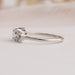Side view of oval cut cluster diamond ring in 14k white gold.