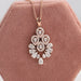 Glittering halo diamond necklace made with brilliant pear cut diamonds in a floral style 