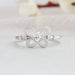Pear cut butterfly shaped diamond engagement ring with round accent stones and in white gold