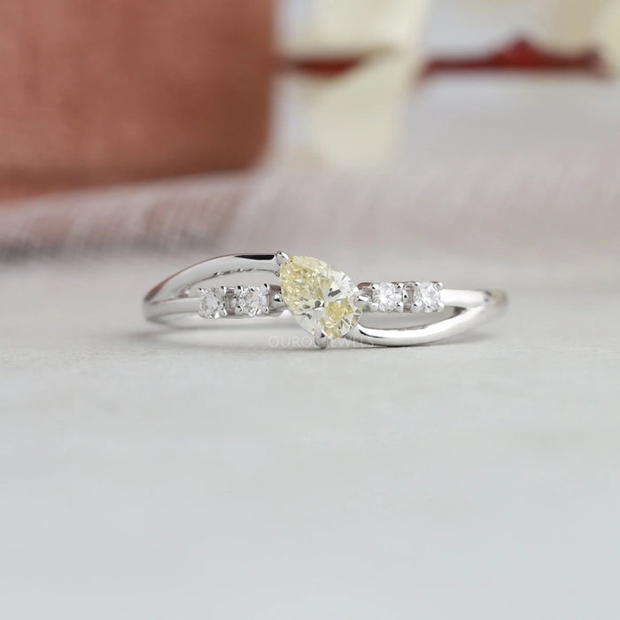 Oval shaped yellow diamond ring with bypass curved band with 3 traditional prongs