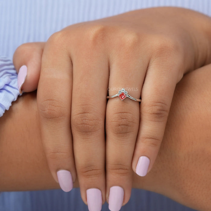 In finger Front view of pink princess cut  dainty ring crafted with curved band in 14k white gold.
