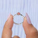 In two finger front look of princess pink cut diamond ring with curved band.
