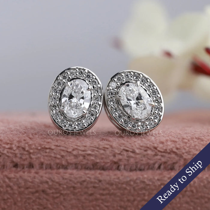 Oval cut lab grown diamond stud earrings with a lovely halo of round diamonds 