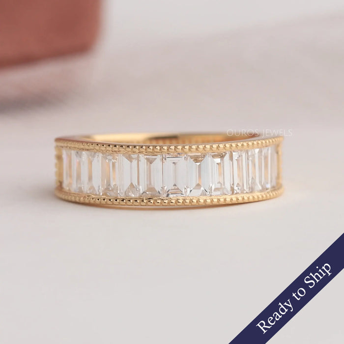 Front look of baguette diamond wedding band in yellow gold. 