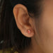 [A Women wearing Pink Radiant Stud Earrings]-[Ouros Jewels]