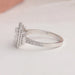 Round accent stones studded on 14k white gold shank of radiant cut lab diamond engagement ring