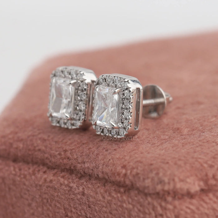 A halo stud screw back earrings, set with lab grown radiant brilliant cut diamonds and round diamonds.
