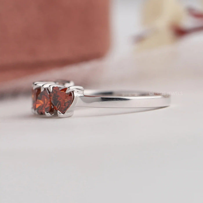 Side look of five stone heart shape lab made diamond wedding ring
