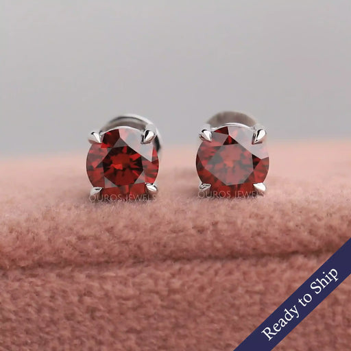 Red round lab grown diamond stud earrings with claw prongs in 14k white gold