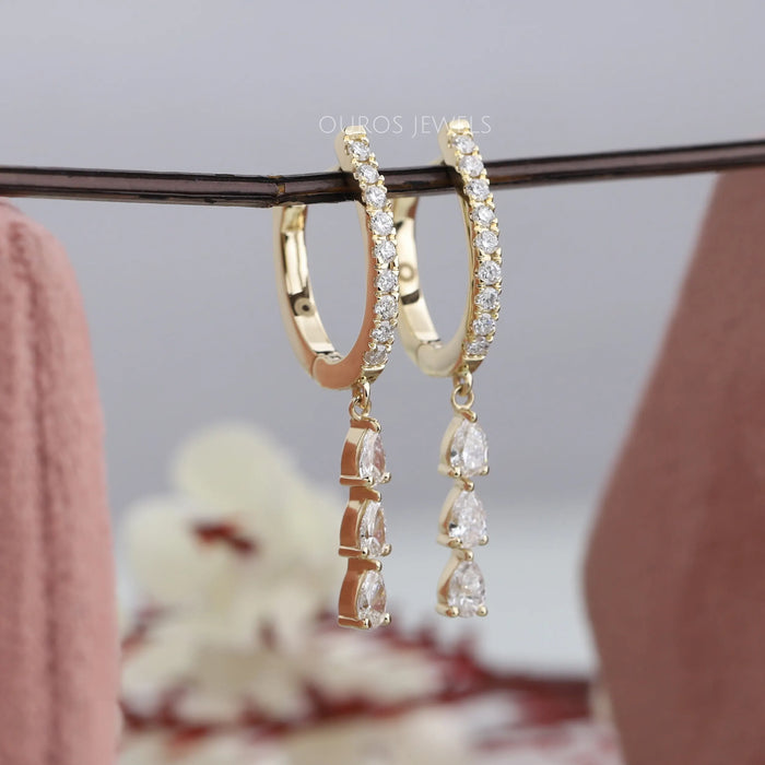 Shining and sparkling pear and round diamond drop and dangle earrings crafted in solid yellow gold and with lever back setting