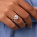 In finger look of three stone emerald cut lab created diamond engagement ring