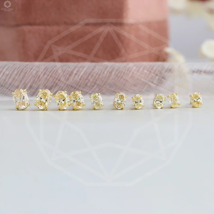 Combined stud earrings with claw prongs and oval shaped lab made diamonds