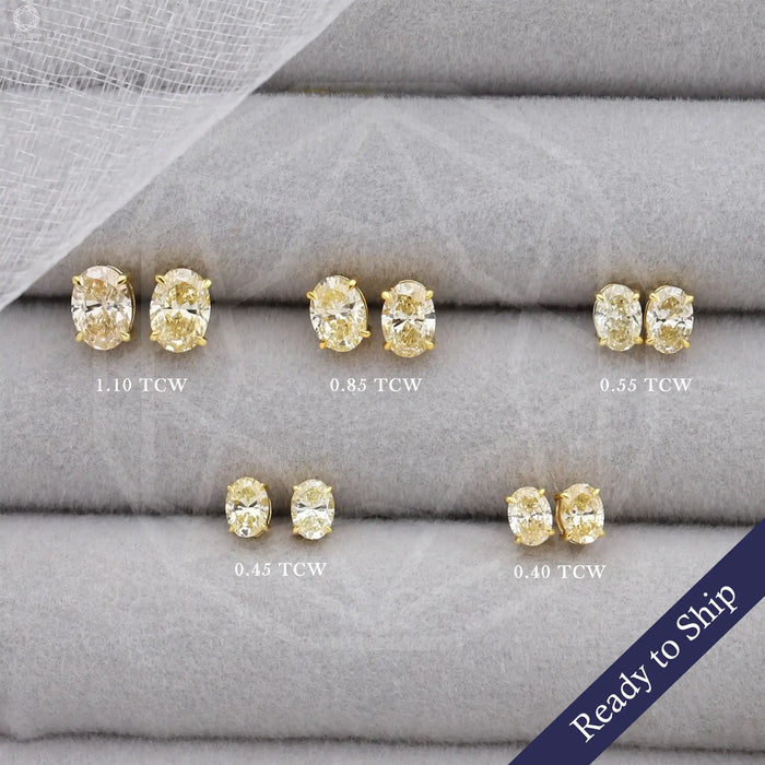 Yellow oval shaped lab grown diamond solitaire stud earrings in 14k yellow gold