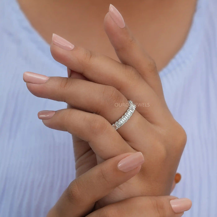 In finger side look of emerald cut lab diamond wedding ring