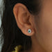 [A Women wearing a Green Oval Halo Studs]-[Ouros Jewels]