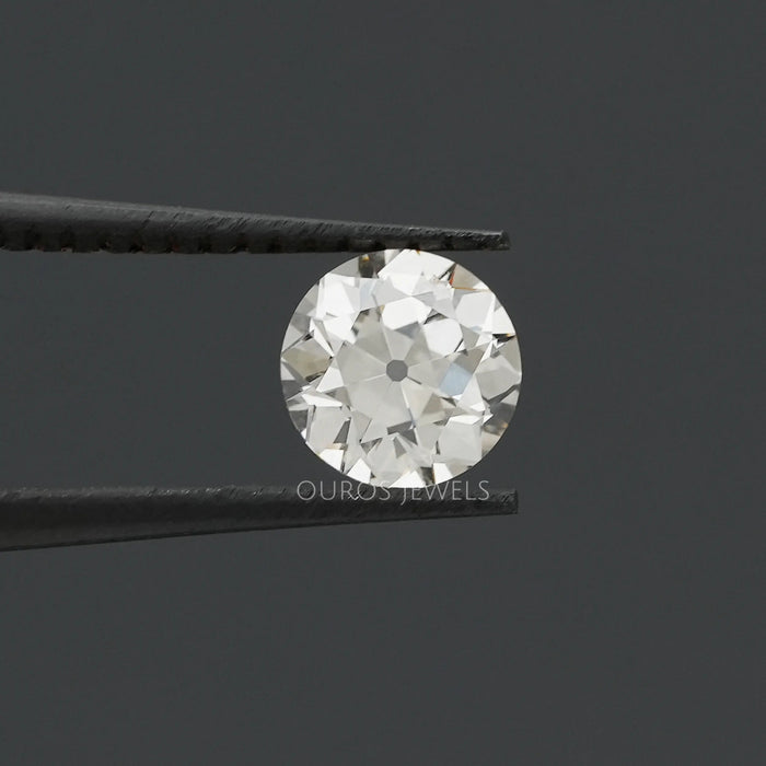 [Old European round cut lab made diamond in tweezer]