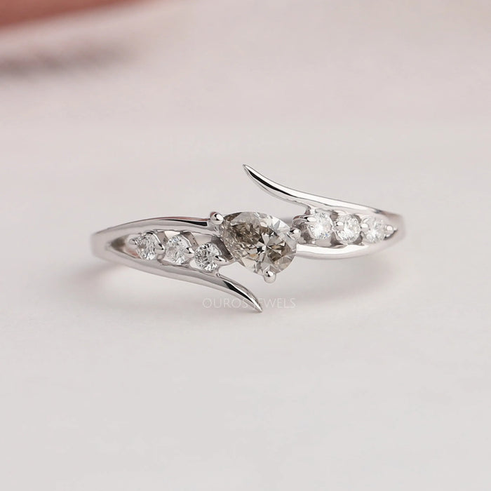 Front view of olive pear shaped diamond bypass ring. This engagement ring inspired by wedding ring.
