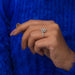 In finger side look of fancy green oval cut diamond wedding ring