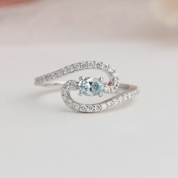Oval and round cut diamond engagement ring with 4 prong setting