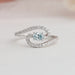 Oval and round cut diamond engagement ring with 4 prong setting