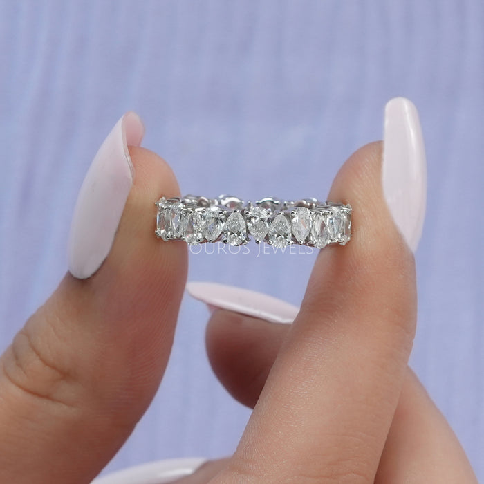 [A Women holding Pear Cut Lab Diamond Eternity Band]-[Ouros Jewels]