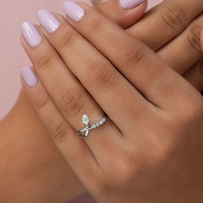 Cross hand finger front view of par cut infinity shape dainty ring inspired by wedding & engagement ring