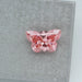 Butterflt Cut Pink Loose Diamond on Grey Surface 