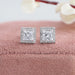 A shining pair of halo princess cut lab made diamond stud earrings in 14k white gold