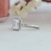 Side look of radiant cut lab made diamond engagement ring with sparkling halo of round diamonds