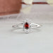 A close up look of split shank diamond engagement ring made with red oval conflict free diamond
