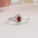 Red Oval Cut Halo Diamond Ring is a timeless masterpiece that exudes elegance and glamour