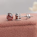 A pair of stud earrings with round solitaire diamonds and claw prongs with screw back setting