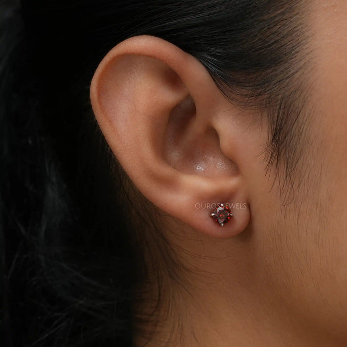 In ear look of red round lab created diamond earrings