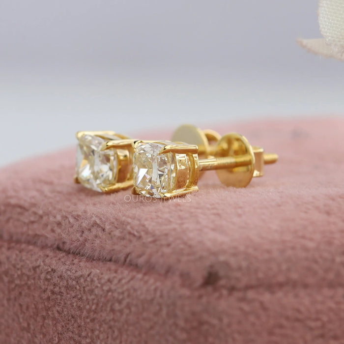 A pair of sparkling diamond earrings with a screw back mechanism for secure fastening