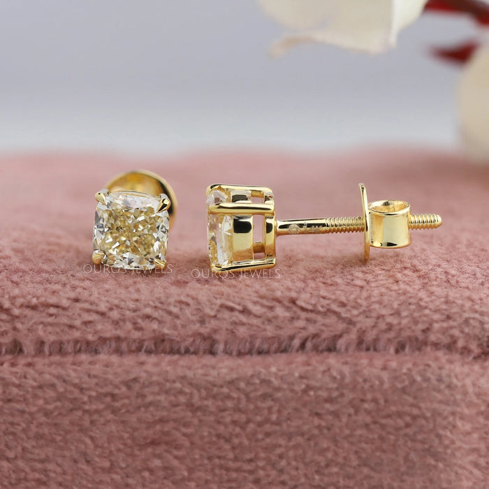 Lustrous yellow gold cushion cut solitaire earrings with screw back setting\