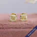 Yellow cushion lab grown diamond solitaire stud earrings crafted with claw prongs in 14k yellow gold