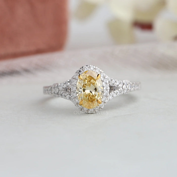 Yellow oval cut diamond ring mad with claw prongs and a split shank setting