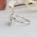 14k white gold curved shank of flower shaped lab made diamond engagement ring