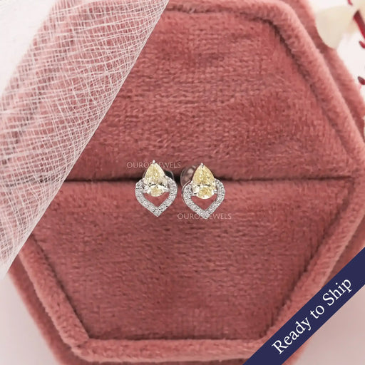 Yellow pear shaped lab grown diamond stud earrings with eye catching halo of round diamonds