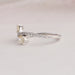 Round Accent Stones Studded On 14k White Gold Curved Shank Of Pear Shaped Yellow Diamond Ring