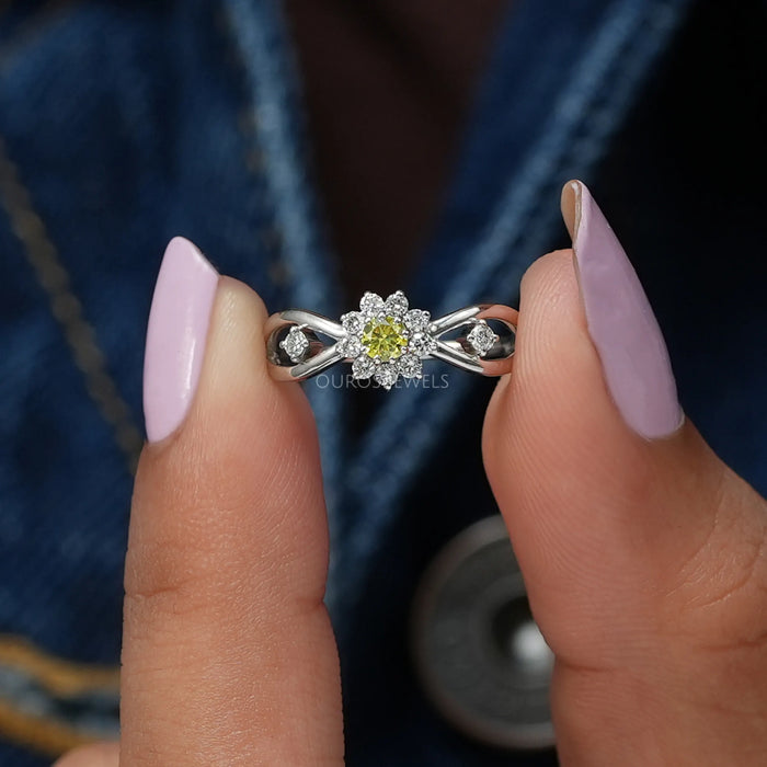Close up look of yellow round diamond engagement ring with halo of round diamonds
