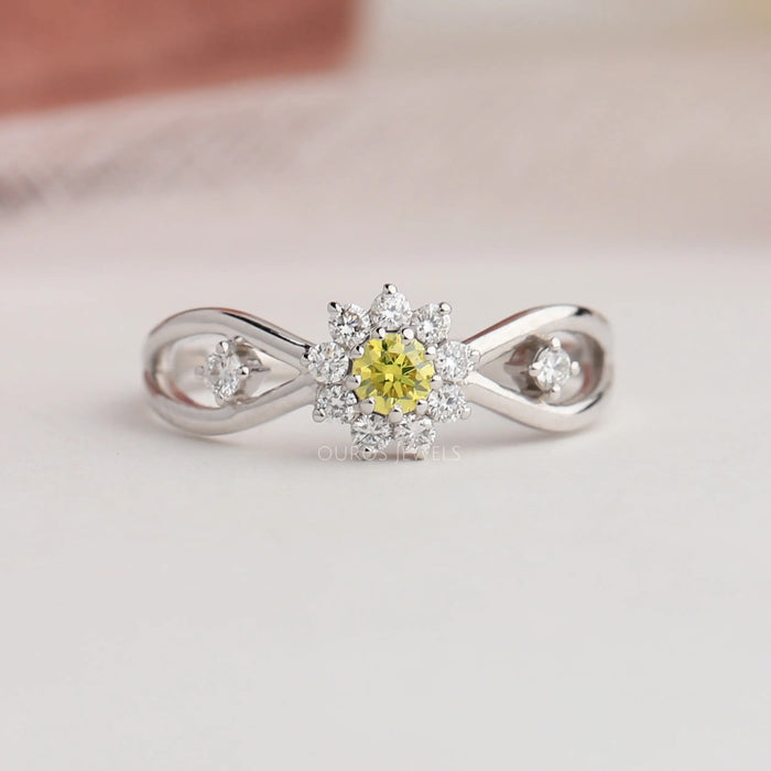 Infinity shape diamond engagement ring with yellow colored round cut diamond